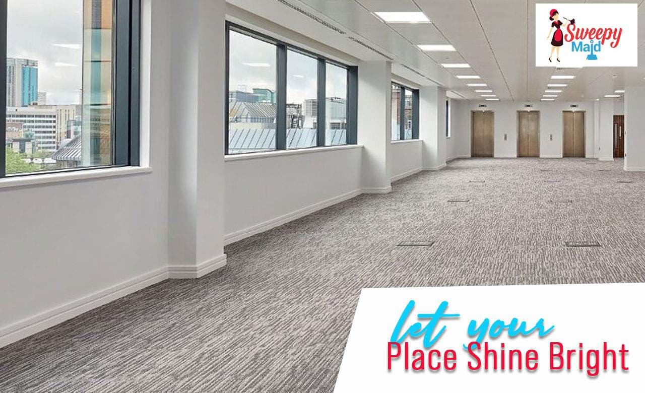 Clean office space with bright windows and carpeting, professional cleaning by Sweepy Maids.