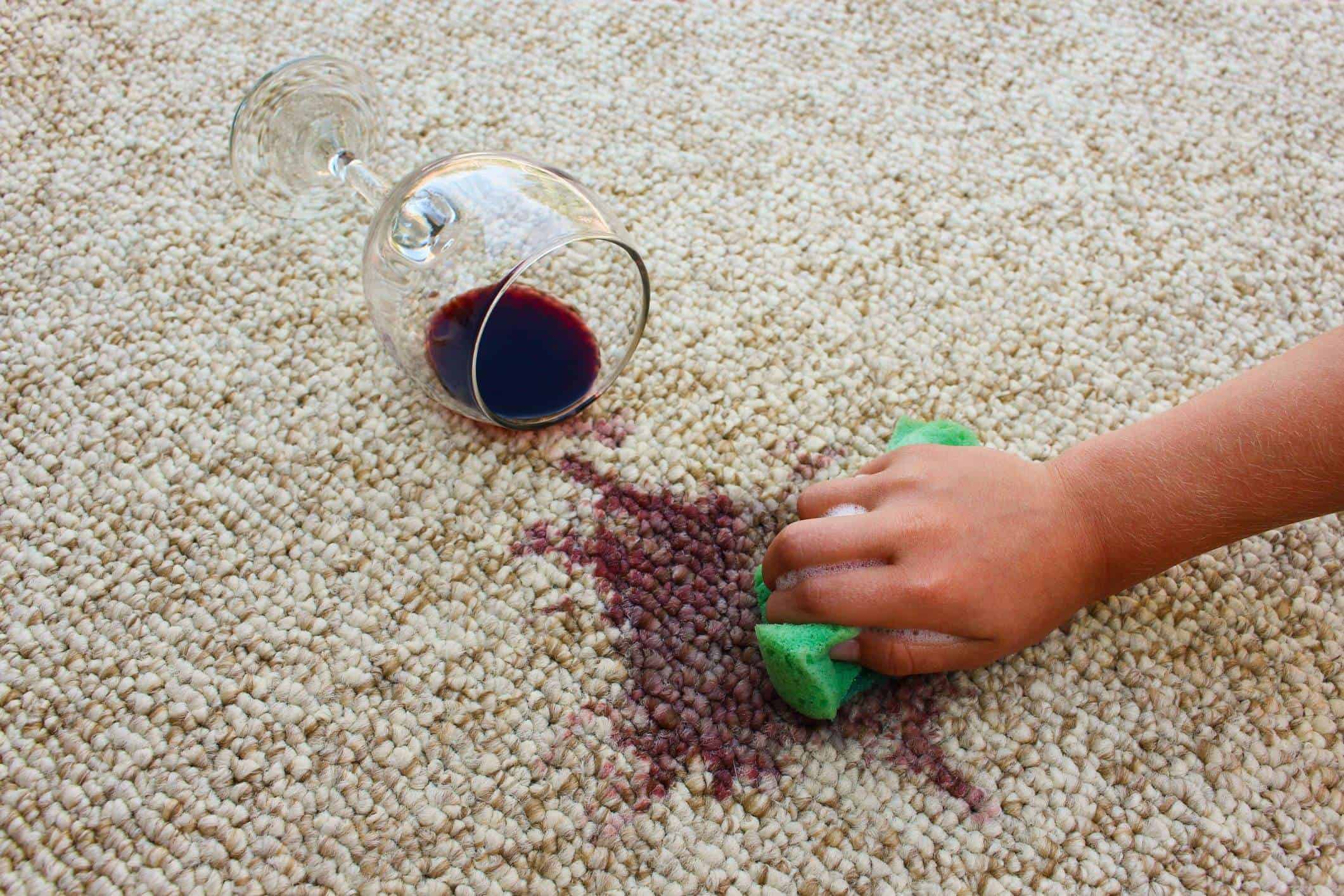 Wine spill on beige carpet cleaned by professional cleaning service.