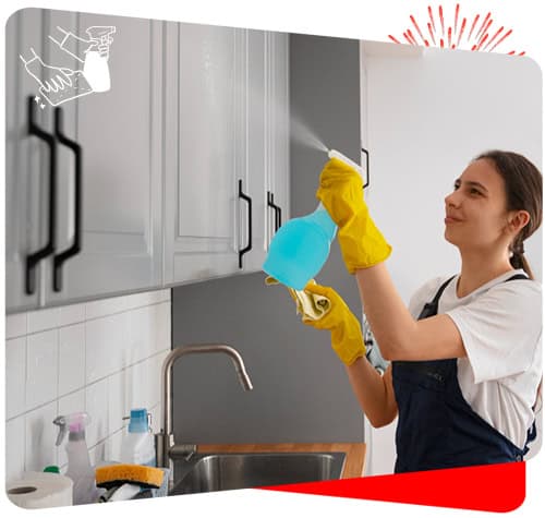 Efficient maid cleaning cabinets with spray at home.